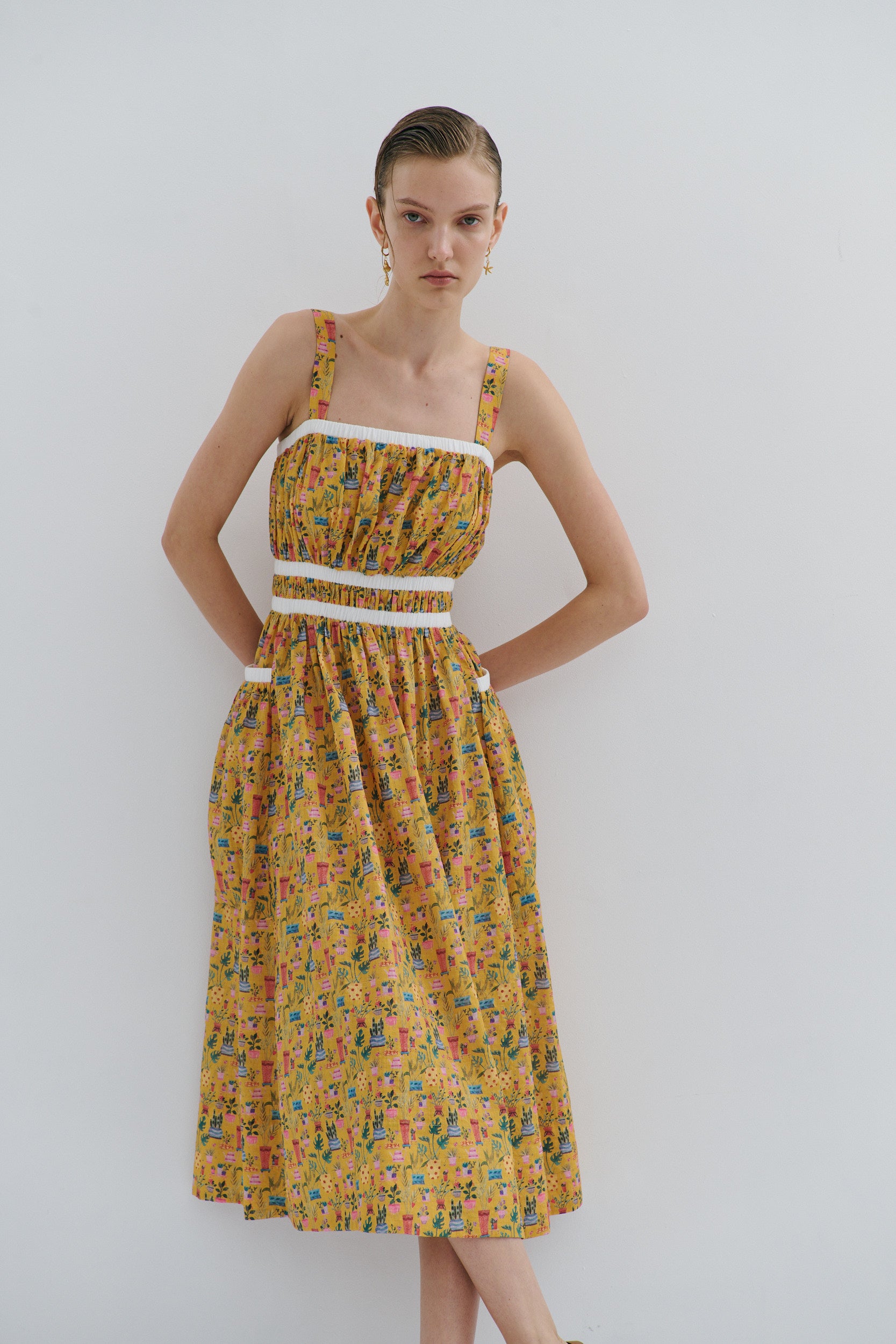 Woman wearing a floral dress against a white background