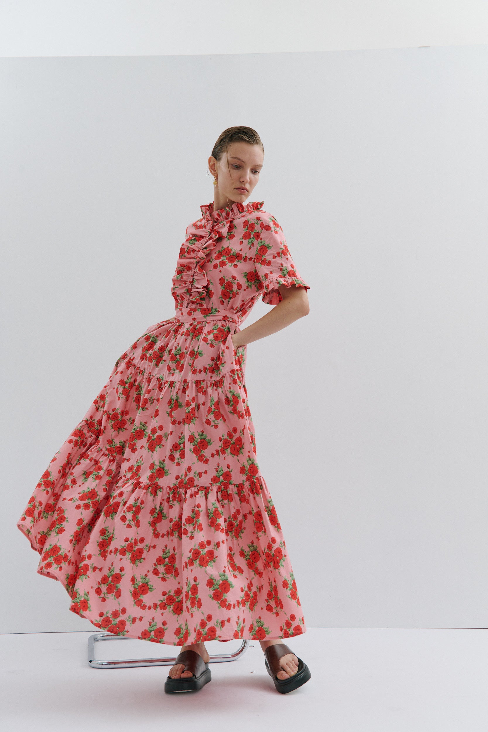 Woman wearing a red floral dress on a white background