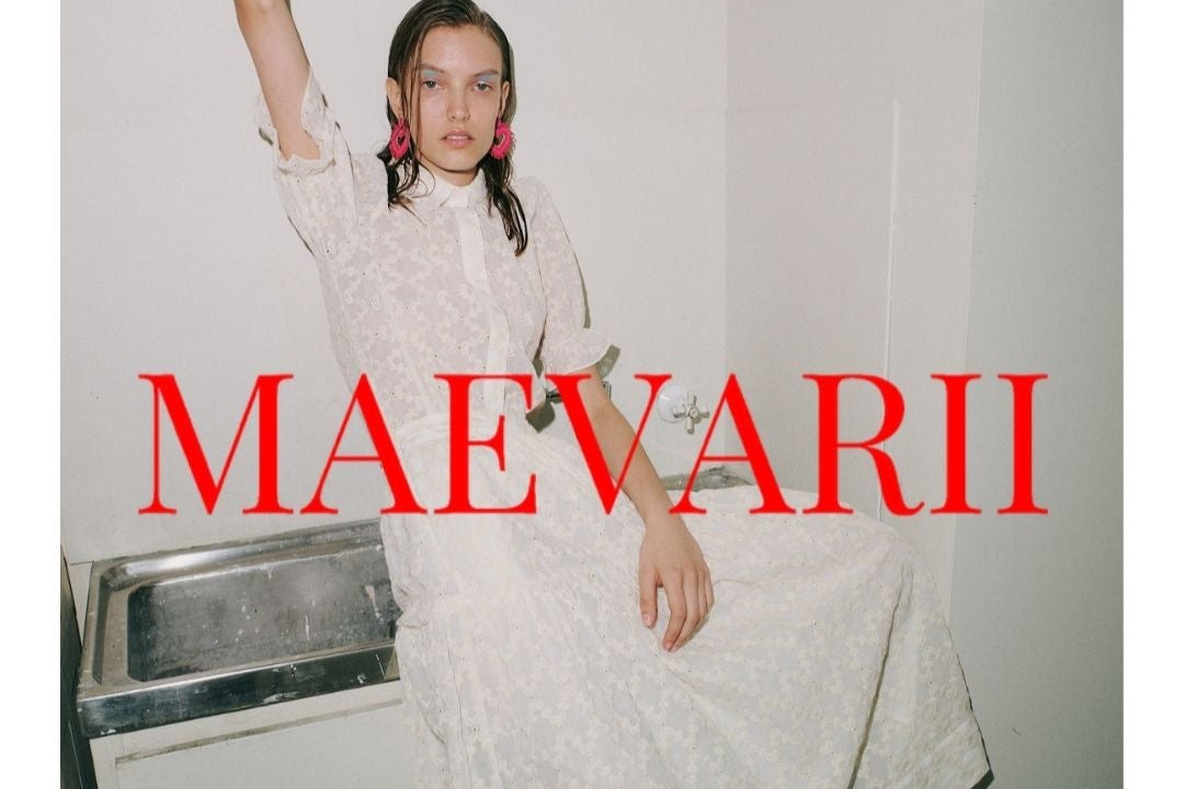 Person in a white dress standing in a bathroom with 'MAEVARII' text overlay.