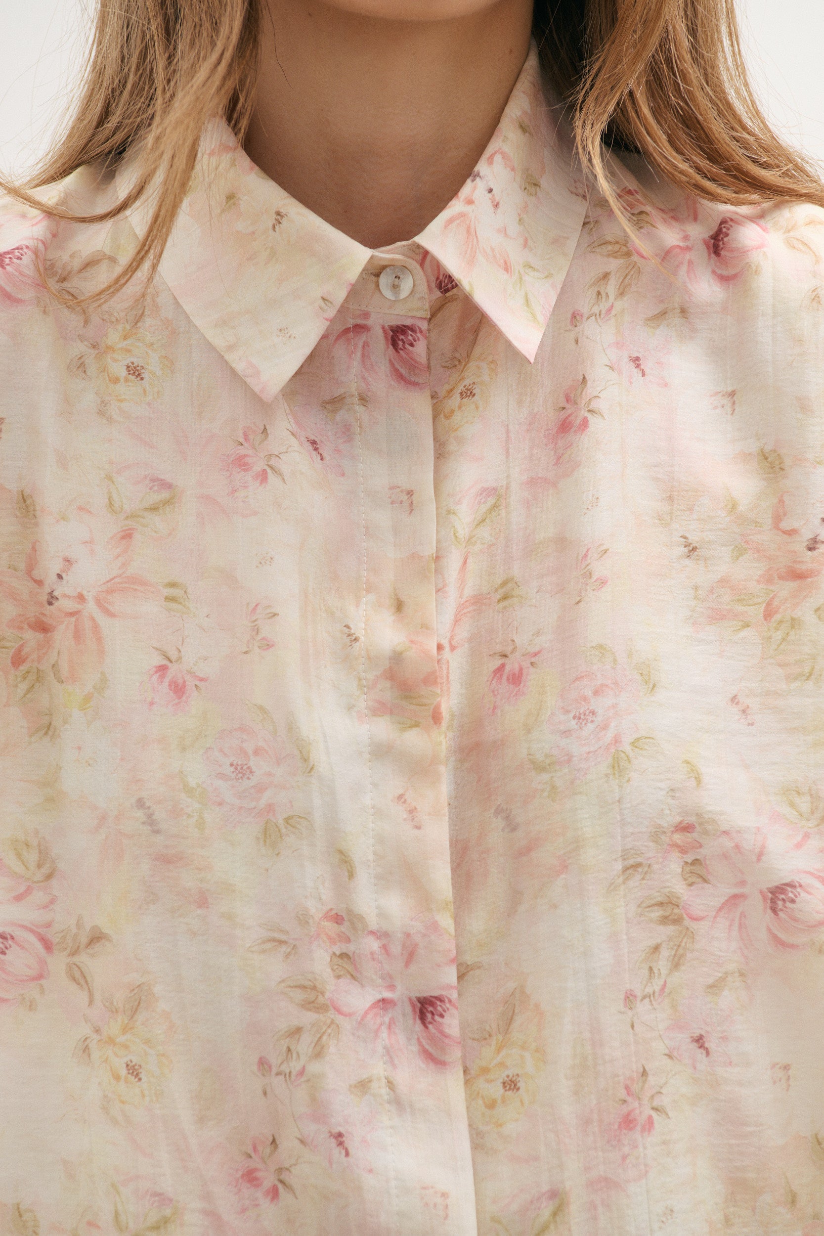 Floral patterned shirt with a focus on the collar and buttons.